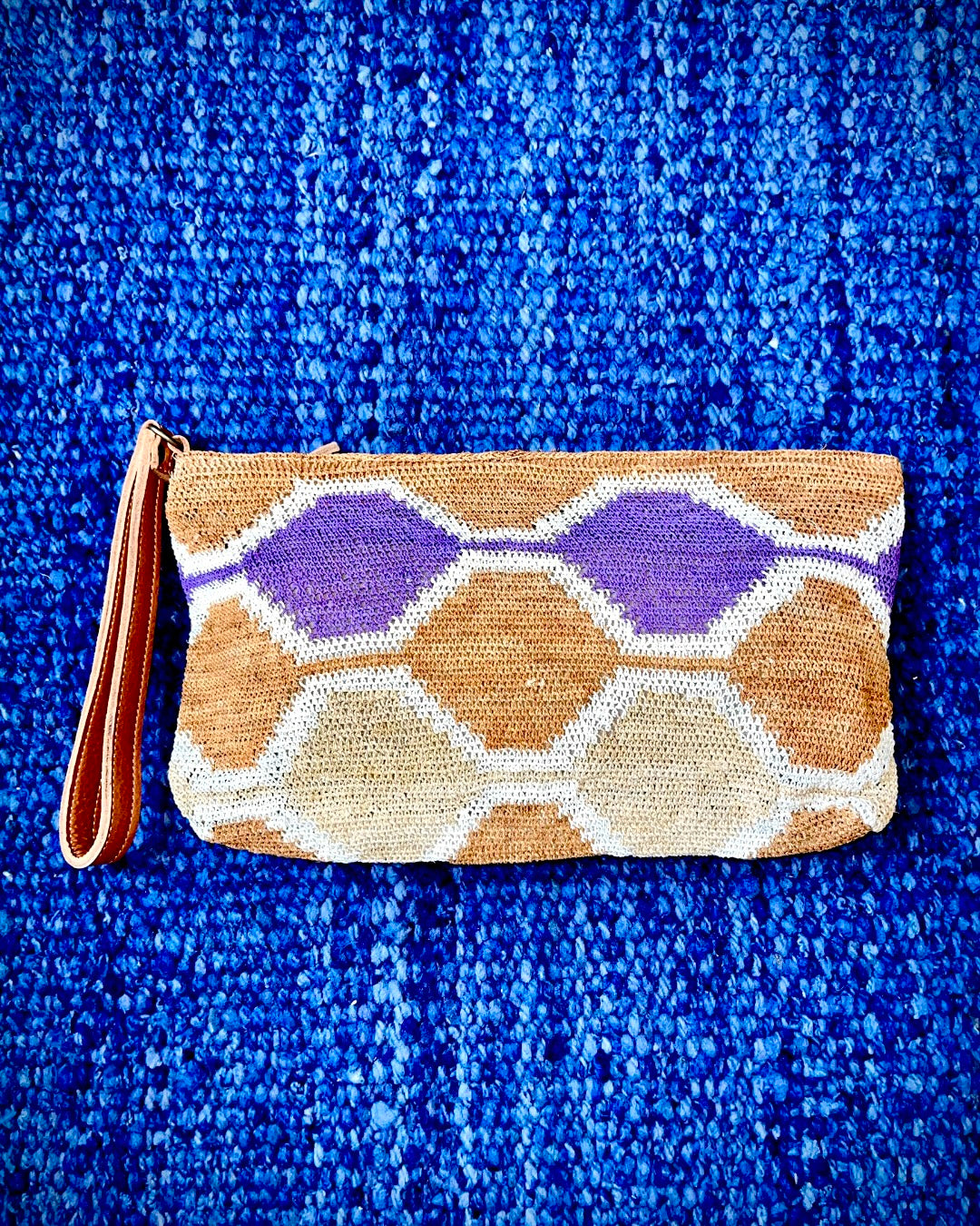 Leather clutch with handwoven chaguar (plant fibre) details. Made ethically from indigenous women artisans in Argentina.