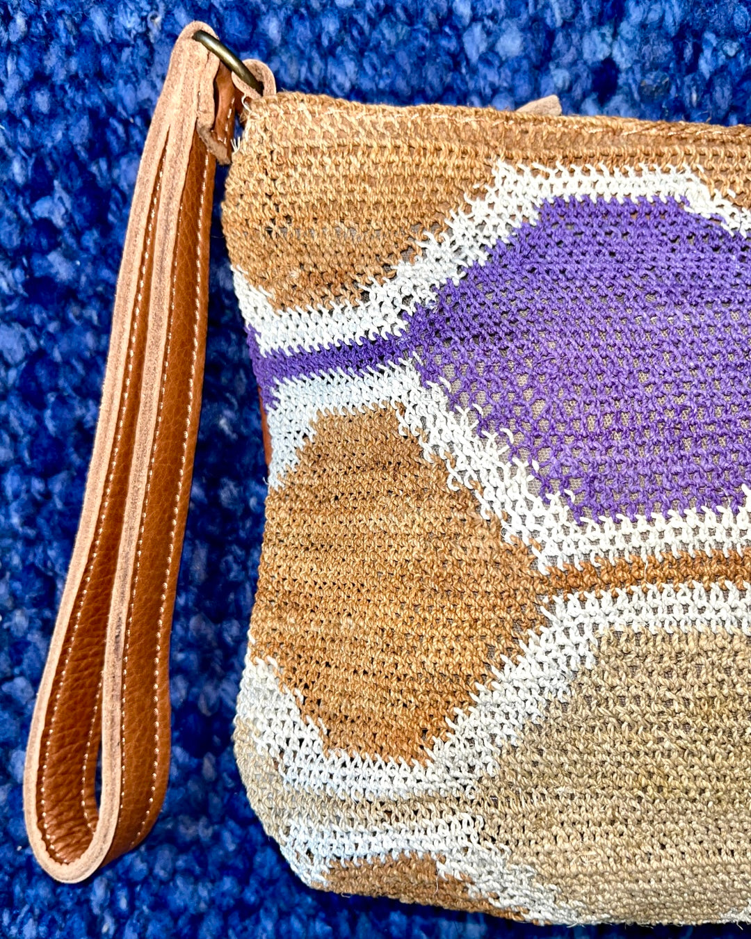 Leather clutch with handwoven chaguar (plant fibre) details. Made ethically from indigenous women artisans in Argentina.