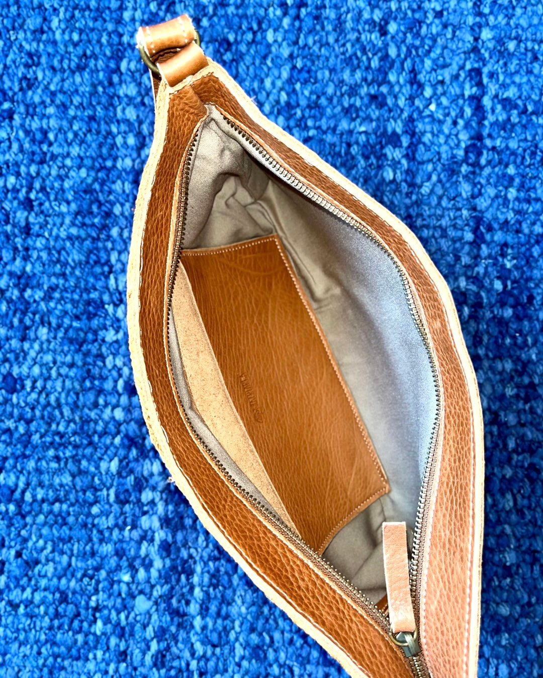 Leather clutch with handwoven chaguar (plant fibre) details. Made ethically from indigenous women artisans in Argentina.